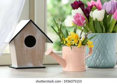 Beautiful Spring Flowers With Birdhouse On Window Sill