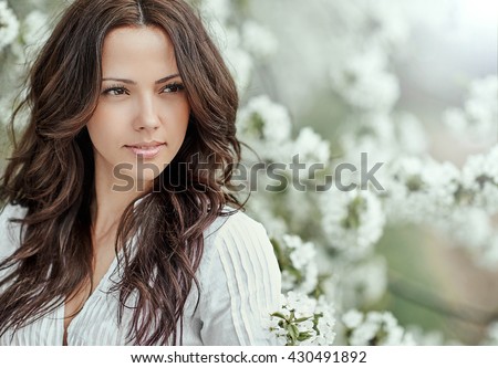 Beautiful spring girl in blooming tree