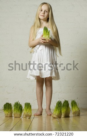 Beautiful spring girl on grass in hands - love of nature concept