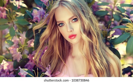 Beautiful Spring   Model Girl   In Fragrant   Flowers  In Summer Blossom Park. Woman In A Blooming Garden . Fashion, Cosmetics & Perfumes . Curly Blonde Hair

