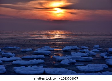 beautiful spring sunrise with ice floe in gdynia, baltic sea coast