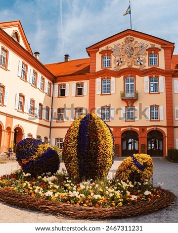 Beautiful spring view with a flower frame in the shape of an easter nest with eggs at Mainau island, Lake Bodensee, Baden-Württemberg, Germany