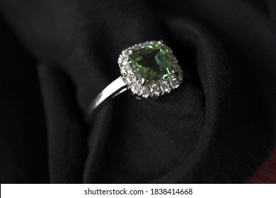 Beautiful square-cut mint green tourmaline and  diamond ring in white gold on black silk background.
