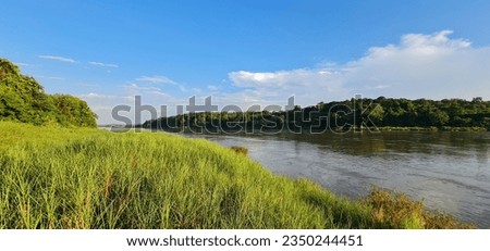 Beautiful sscenery blue sky green grass along river 
