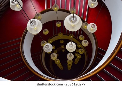 A beautiful staircase with vintage hanging light bulbs. Red floor and white lamp.  - Powered by Shutterstock