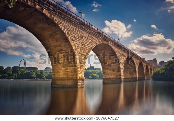 Beautiful stone arch bridge reflection on\
the Mississippi river,  Minneapolis Minnesota ,USA\
