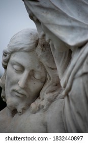 Beautiful stone pieta in a Victorian cemetery. Full frame image in natural light. Selective focus on face of Jesus.