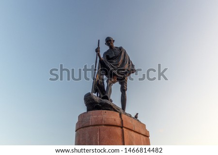 beautiful stone statue of Statue of Mahatma Ghandi with blue sky on background marina beach chennai
