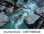 Beautiful stormy mountain river of emerald and blue hues runs over rocks top view. Wild and beautiful nature of Caucasian reserve, river Belaya, Republic of Adygea, Russia.