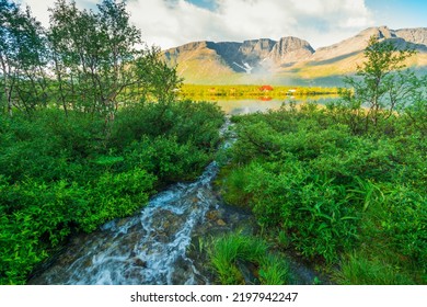 Beautiful Stormy Mountain River Of Emerald And Blue Hues Runs Over Rocks Top View