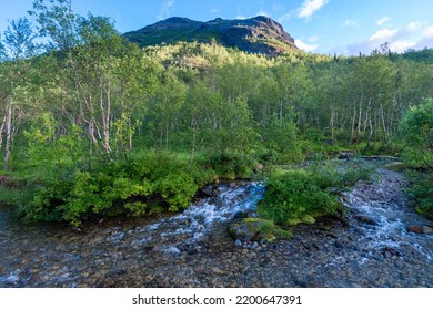 Beautiful Stormy Mountain River Of Emerald And Blue Hues Runs Over Rocks Top View