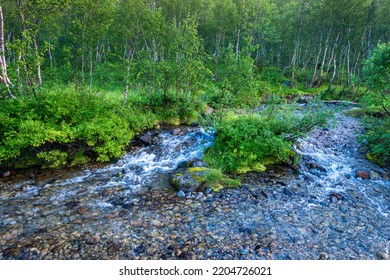 Beautiful Stormy Mountain River Of Emerald And Blue Hues Runs Over Rocks Top View