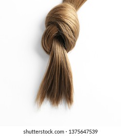 Beautiful Strand Of Brown Hair Tied In Knot On White Background, Top View. Hairdresser Service