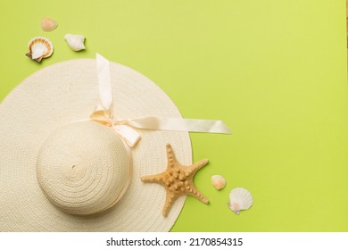 Beautiful Straw Hat And Seashells On Color Background, Top View.