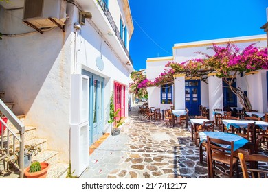 Beautiful street in old traditional Greek cycladic village of Plaka with white houses and colorful doors on Milos Island