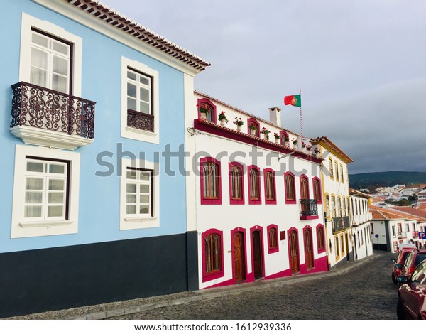 Beautiful street view of bright and colorful  houses\
next to the harbor, in Angra do Heroísmo, Terceira island, Azores,\
Portugal 