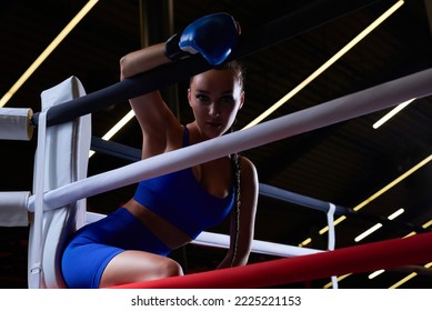 Beautiful And Strong Sportswoman Posing In The Corner Of The Ring. The Concept Of Wrestling And Boxing. Mixed Media