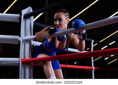 Beautiful And Strong Sportswoman Posing In The Corner Of The Ring. The Concept Of Wrestling And Boxing. Mixed Media