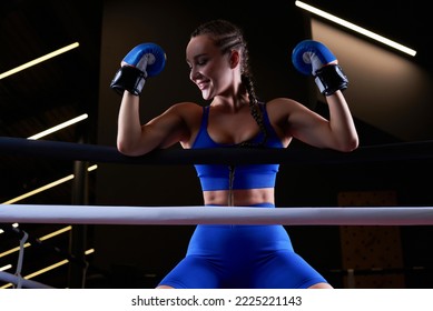 Beautiful And Strong Sportswoman Posing On The Ropes Of The Ring. The Concept Of Wrestling And Boxing. Mixed Media