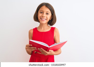 Beautiful student child girl reading red book standing over isolated white background with a happy face standing and smiling with a confident smile showing teeth