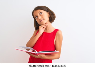 Beautiful Student Child Girl Reading Red Book Standing Over Isolated White Background Serious Face Thinking About Question, Very Confused Idea