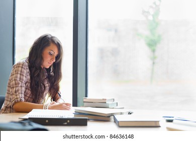 Beautiful Student Writing An Essay In A Library