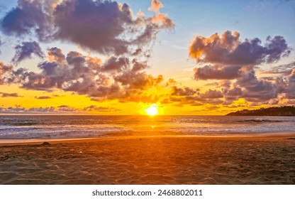 Beautiful stunning colorful and golden sunset in yellow orange red on beach and big wave panorama in tropical nature in Zicatela Puerto Escondido Oaxaca Mexico. - Powered by Shutterstock