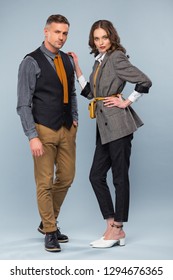 beautiful stylish couple in formal wear looking at camera while posing on grey background - Shutterstock ID 1294676365