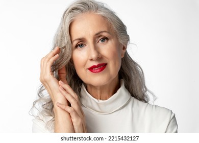 A beautiful stylish and elegant older lady with a smile. Portrait of a beautiful elderly woman with loose gray hair on a white background. - Powered by Shutterstock