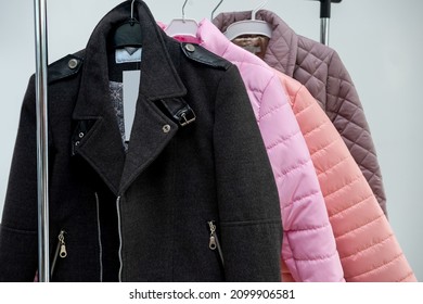 beautiful stylish exquisite incredibly comfortable jackets hang on hangers in the store. Outerwear concept