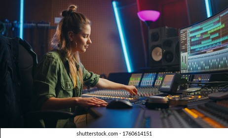 Beautiful, Stylish Female Audio Engineer and Producer Working in Music Recording Studio, Uses Mixing Board and Software to Create Cool Song. Creative Girl Artist Musician Working to Produce New Song - Shutterstock ID 1760614151