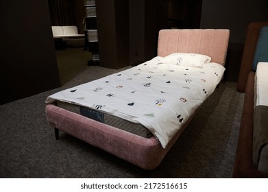 Beautiful Stylish Single Bed For A Baby Girl Upholstered In Pink Pastel Velour Fabric Displayed For Sale In A Furniture Showroom. Home Interior Design Concept. Home Design, Bedchamber, Healthy Sleep