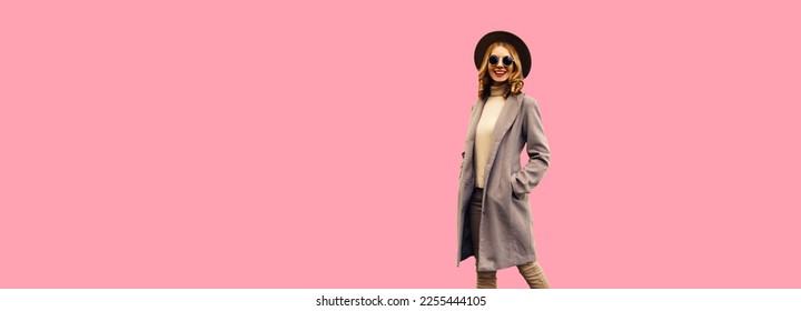 Beautiful stylish smiling young woman model wearing brown round hat and coat on pink background, banner blank copy space for advertising text - Shutterstock ID 2255444105
