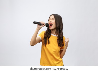beautiful stylish woman singing karaoke isolated over white background. - Shutterstock ID 1278460312