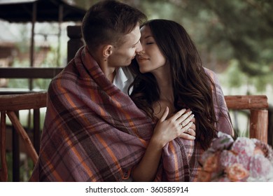 Beautiful stylish young couple in love kissing under the blanket celebrating Valentine's Day. - Powered by Shutterstock