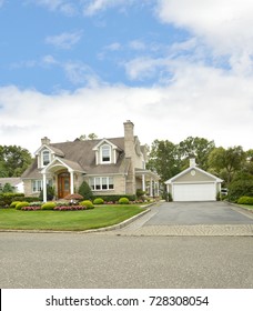 Beautiful Suburban Brick Cape Cod Style Home Blue Sky Clouds USA