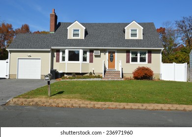 Beautiful Suburban Cape Cod Style Home Autumn Day Residential Neighborhood Sunny Clear Blue Sky USA