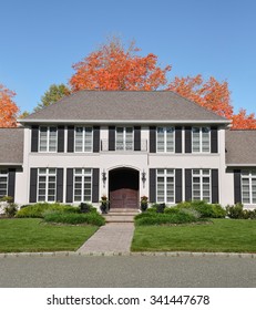 Beautiful Suburban McMansion Georgian Style Home Landscaped Cobblestone Curb Autumn Fall Season Sunny Blue Sky Residential Neighborhood USA