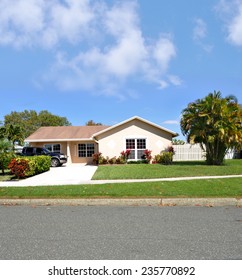 Beautiful Suburban Ranch Style Single Family Home Sunny Residential Neighborhood Blue Sky Clouds USA