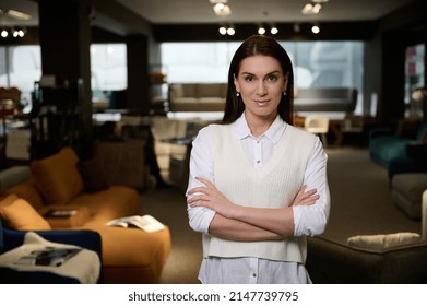 Beautiful Successful Business Woman, Confident Female Sales Manager Of A Furniture Store Looking At Camera Smiling With Arms Crossed