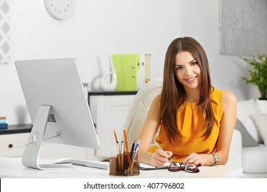 A beautiful successful woman working at the modern office