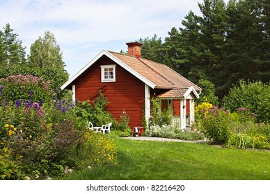 Beautiful Summer Cottage With Flower In The Garden.