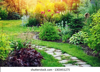 Beautiful Summer Cottage Garden View With Stone Pathway And Blooming Perennials