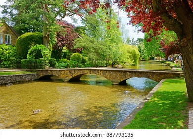 A beautiful summer day showing the River Windrush flowing through Bourton on the Water, also known as The Venice of the Cotswolds, Gloucestershire, England, United Kingdom