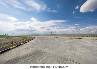 beautiful summer landscape, highway and green field with blue sky with white clouds