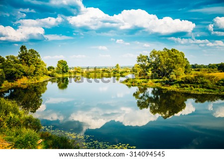 Beautiful summer landscape with river and blue sky in Belarus Russia