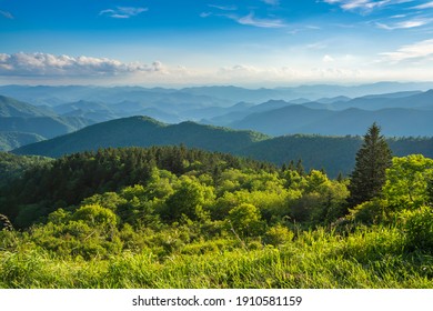 Beautiful summer mountain landscape. Blue sky with  clouds over layers of green hills and  mountains.  Copy space. North Carolina. Blue Ridge Parkway.USA.