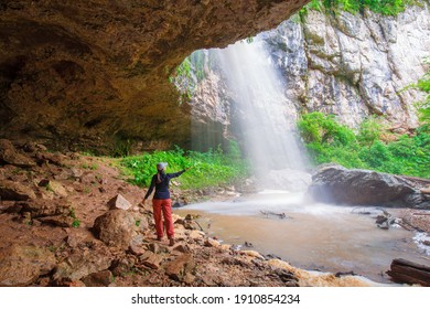 Beautiful Summer In Mountains. Northern Country Russia Caucasus. Amazing Nature Waterfall. Travel  Landscape View. Inspiring Flora In Mainsail Cave. A Woman Enjoy A Sport Hike In Holidays.