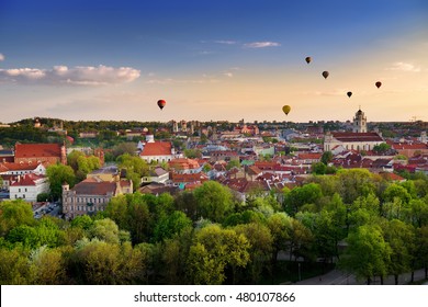 Beautiful summer panorama of Vilnius old town with colorful hot air balloons in the sky, taken from the Gediminas hill