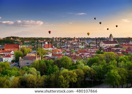 Beautiful summer panorama of Vilnius old town with colorful hot air balloons in the sky, taken from the Gediminas hill